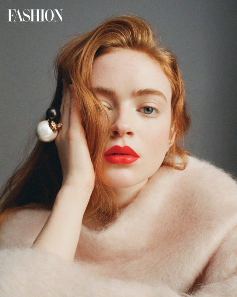 sadie sink in a pink fur top and red lips