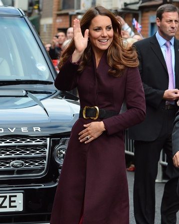 Kate Middleton wears an aubergine coat of her own design