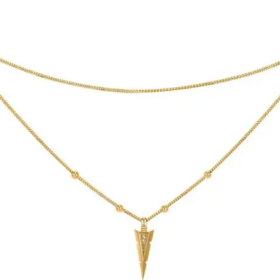 A gold necklace featuring an arrowhead decorated with diamond