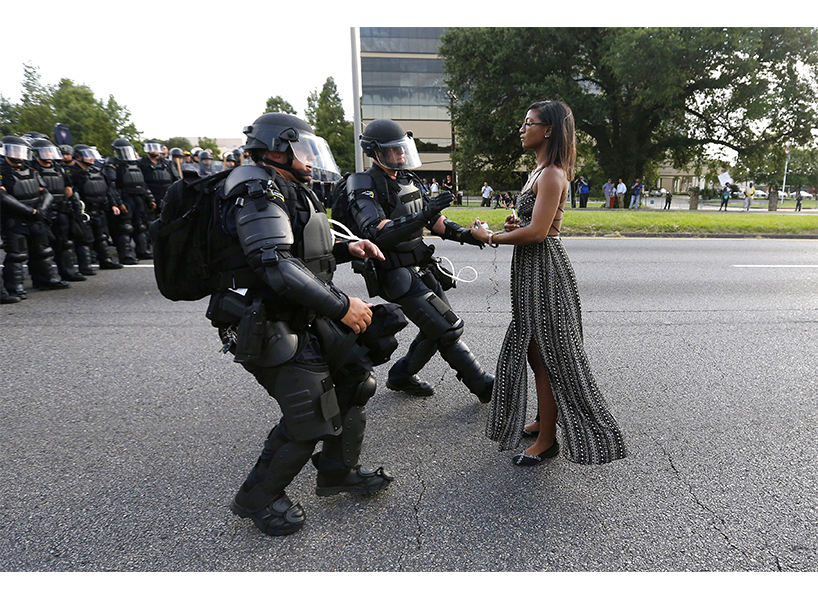 Ieshia Evans, a nurse from Pennsylvania, stands calmly before police in riot gear outside Baton Rouge Police Headquarters protesting the shooting death of Alton Sterling; July 9, 2016 (Photo: Jonathan Bachman/Reuters/Newscom)