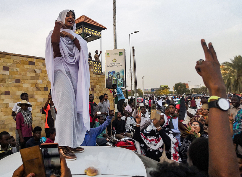 Alaa Salah, a Sudanese woman propelled to internet fame after clips went viral of her leading powerful protest chants against President Omar al-Bashir, addresses protesters during a demonstration in front of the military headquarters in the capital Khartoum on April 10, 2019. (Photo: Getty Images)