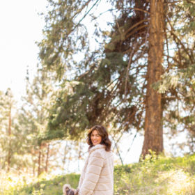 Jillian Harris in woods wearing fall coat