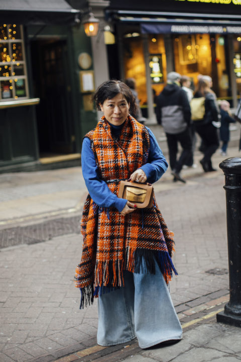 woman with blue sweater and plaid vest