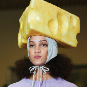 model with large yellow cheese hat