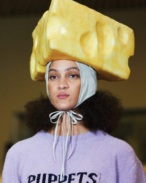 model with large yellow cheese hat