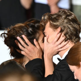 kaia gerber and austin butler kiss with their hands on each other's cheeks on the cannes film festival 2022 red carpet premiere for "elvis"