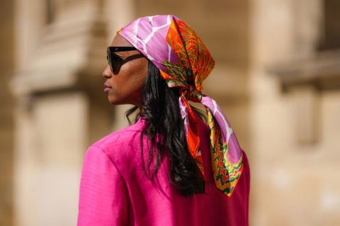 influencer wearing a pink bandana and pink blazer during fashion week