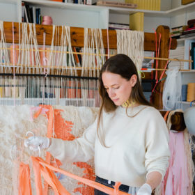 Ann Cathrin November Høibo in art studio holding pink fabric