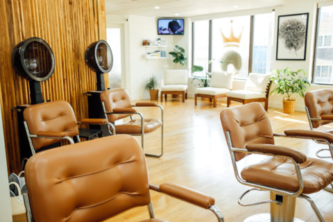 Inside Toronto-based Crown and Glory Curly Hair Salon.The chairs are beige, the salon is empty and the sun is shining