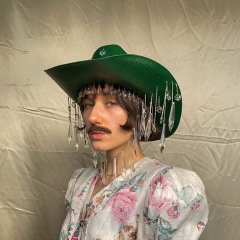 person in a green cowboy hat and vintage dress from canadian clothing brand gorm