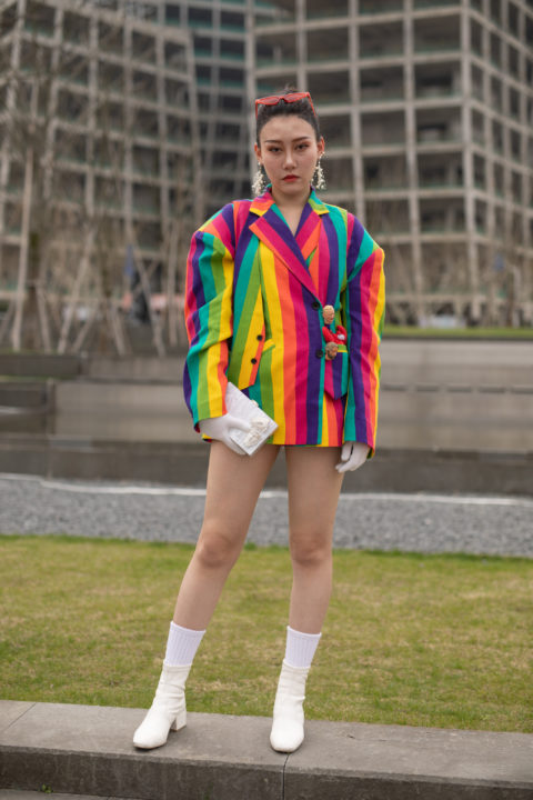 woman in a rainbow coloured jacket