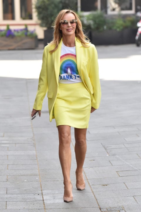 woman in a yellow skirt suit and a shirt with a rainbow on it inspo for what to wear to pride 2022