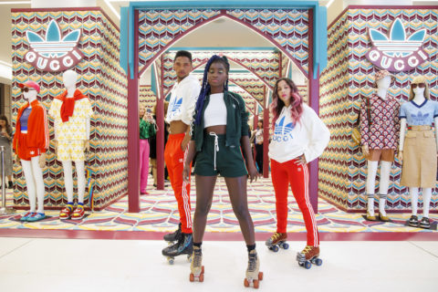 three roller skating professionals pose in the gucci x adidas pop up
