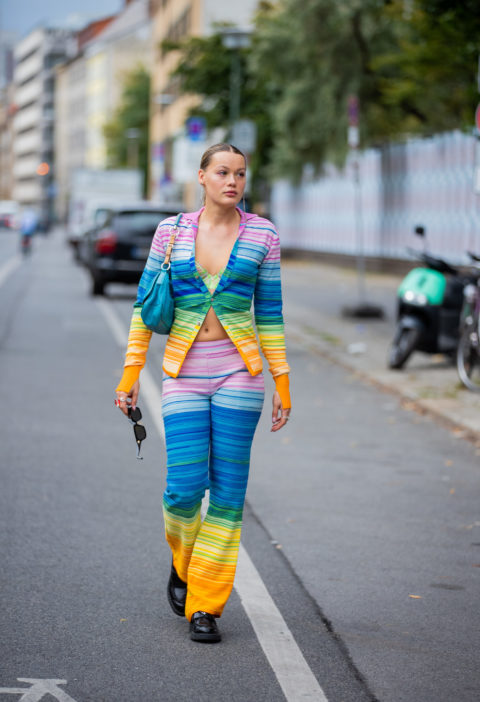 woman in rainbow cardigan and pants inspo for what to wear to pride 2022