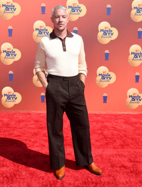 diplo attends the 2022 mtv movie & tv awards red carpet in a collared white top and brown pants