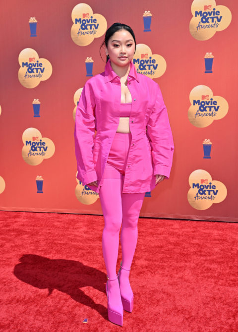 lana condor on the 2022 mtv movie & tv awards red carpet in a pink crop top, jacket and pants