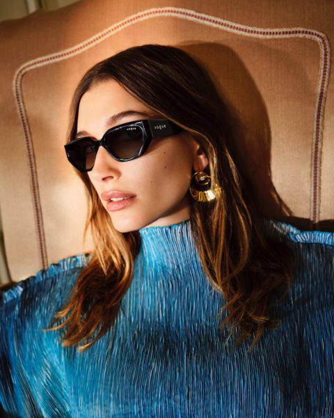 hailey rhode beiber wearing sunglasses and a blue texture turtleneck