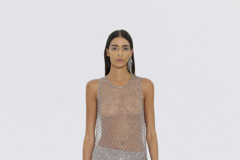 Model walking in mesh see-through Fendi dress with exposed flat stomach for haute couture week fall 2022