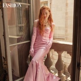 sadie sink in a long latex pink dress with pink gloves