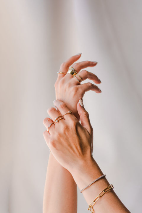 Two hands are wearing rings from Parisian jewelry