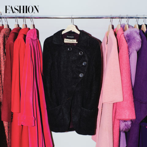 A black Dior coat on a rack of colourful coats