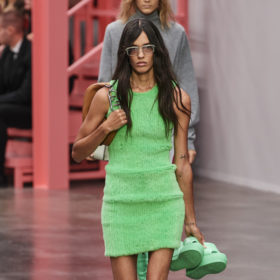 Fendi Spring 2023 model in green dress holding shoes