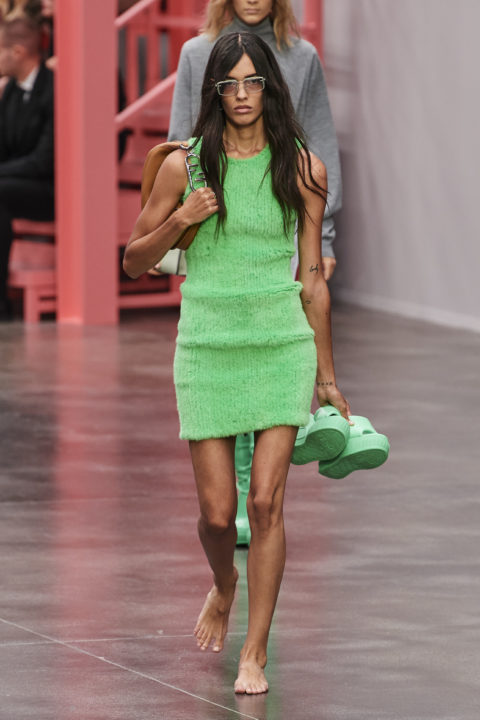 Fendi Spring 2023 model in green dress holding shoes