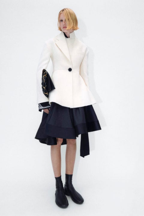 model wears white jacket and black skirt with black bag from proenza schouler pre-spring 2023