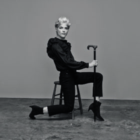 Selma Blair for Gap sitting on a stool holding her cane