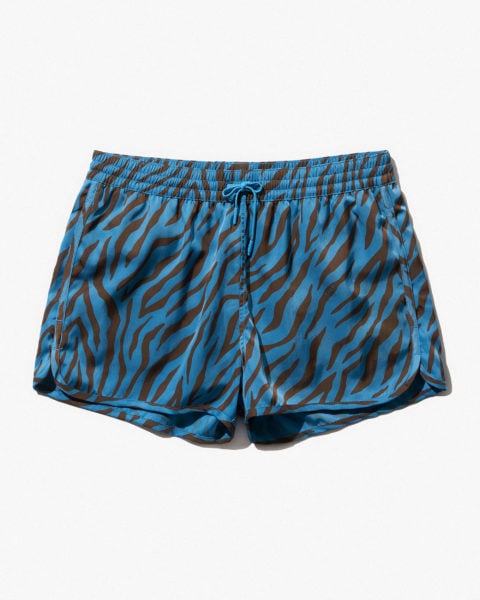 statement swimwear: dark blue swim shorts with a black zebra print pattern