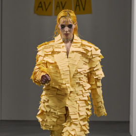 Model walking in a Post-it suit at Avavav Milan Fashion Week