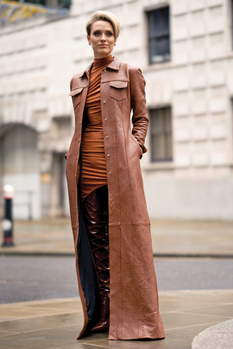 Woman wearing brown leather trench, latte dressing