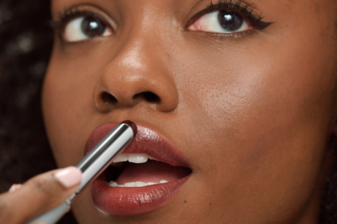 Woman applying Clinique Black Honey Lipstick