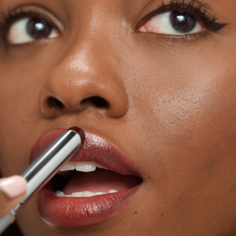 Woman applying Clinique Black Honey Lipstick