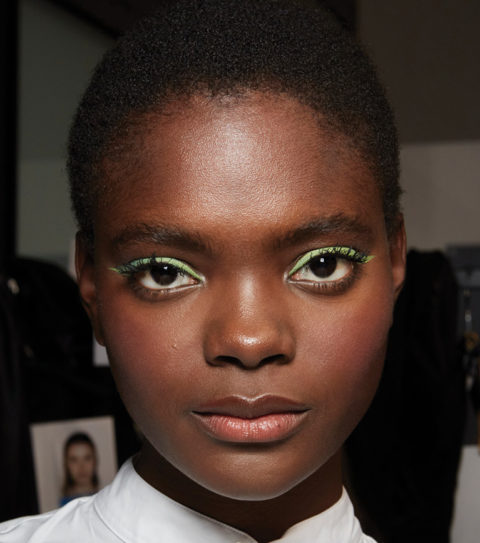 Model backstage wearing green pastel eyeshadow
