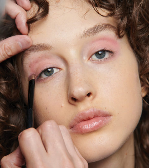 Model backstage wearing pink pastel eyeshadow