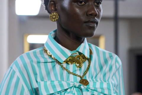 model wearing a gold necklace and earrings, est gold jewellery