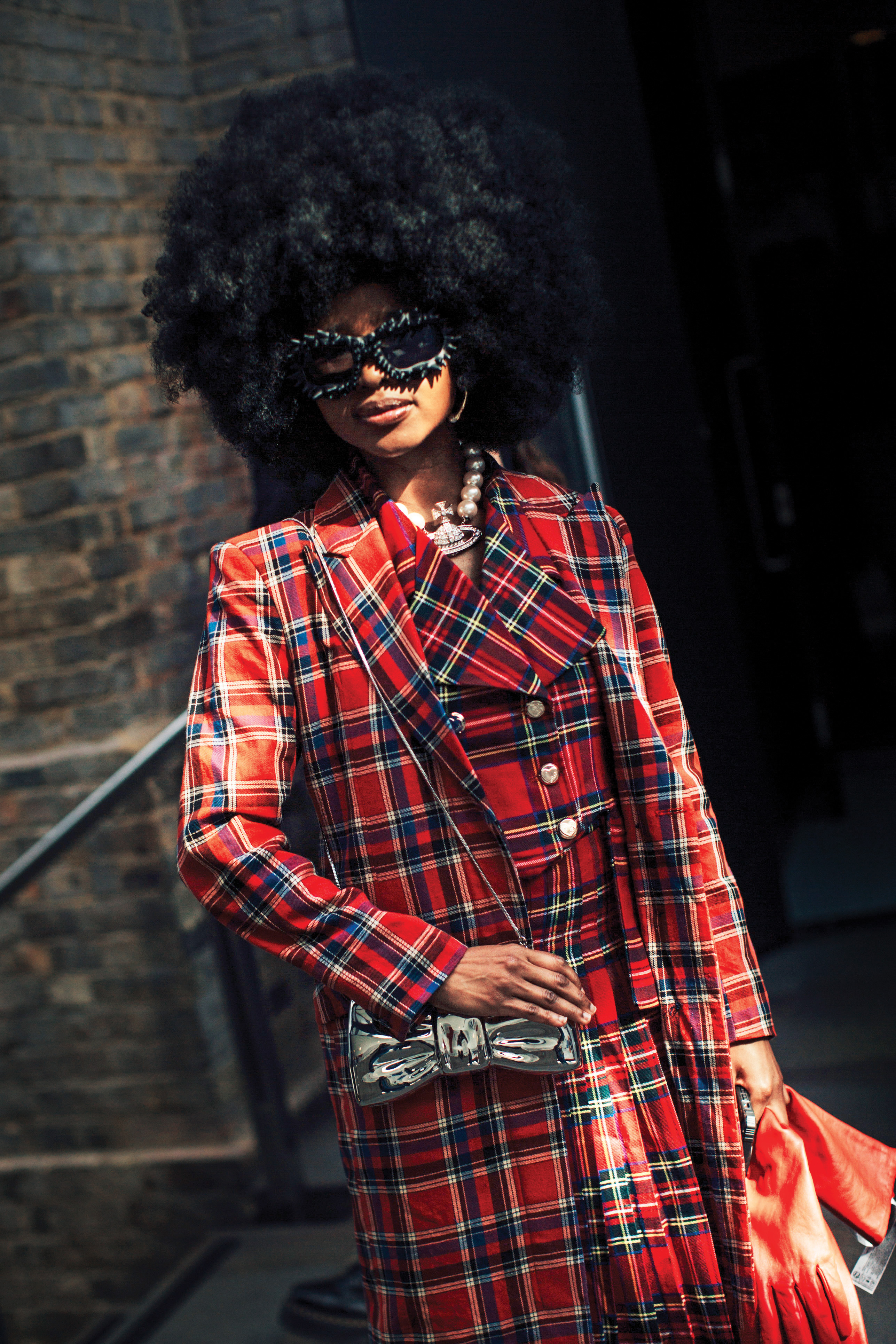 street style photo of a chic woman in a red plaid coat