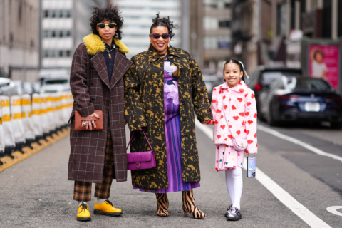 A photo of a family holding hands at New York Fashion Week, mother's day gift ideas