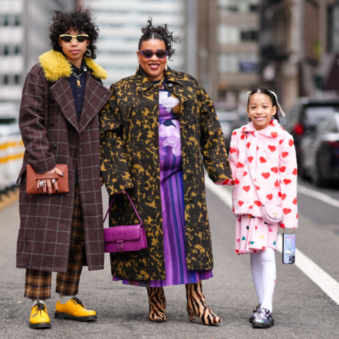 A photo of a family holding hands at New York Fashion Week, mother's day gift ideas
